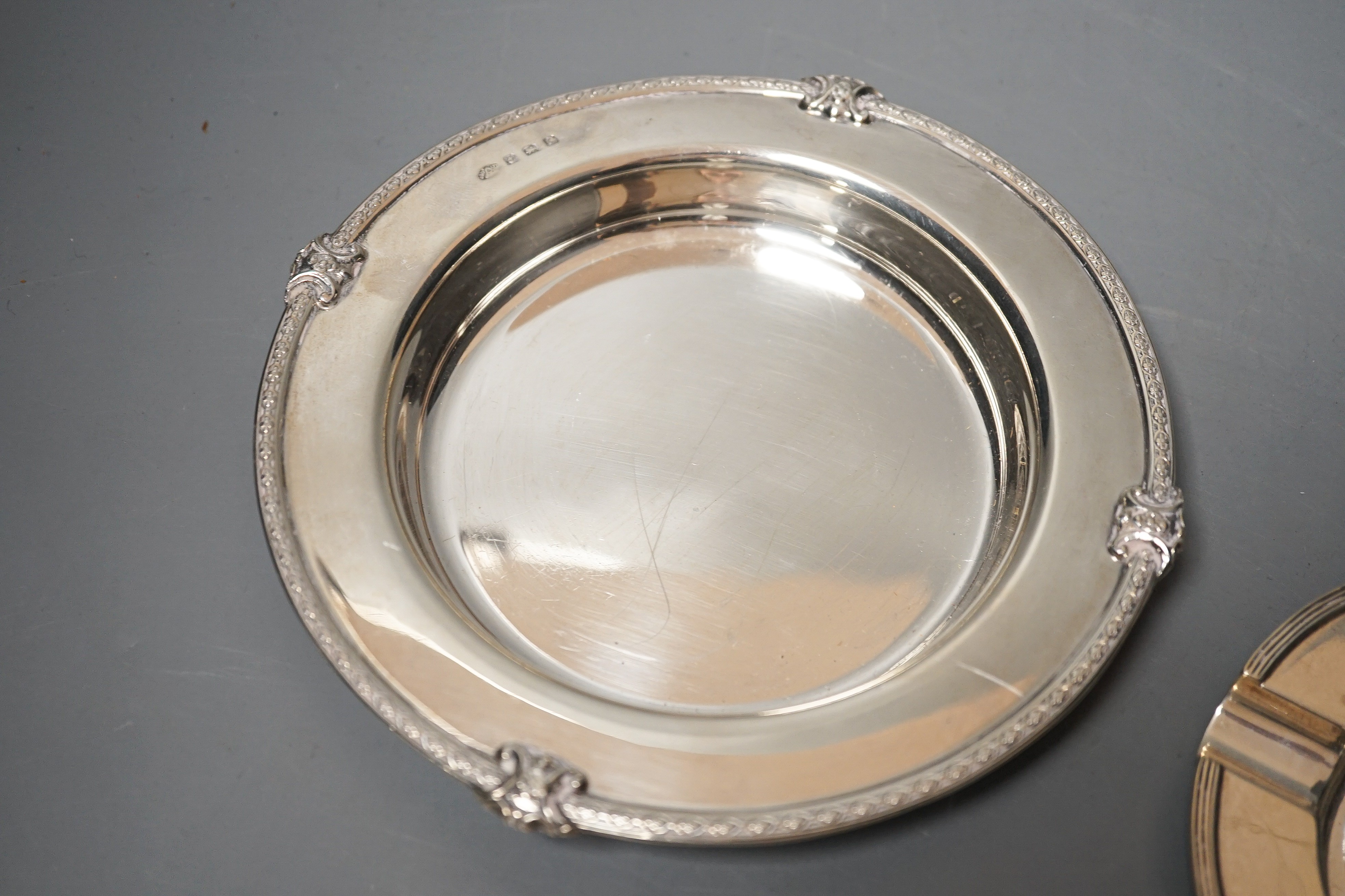 A George V silver shallow dish or stand, Adie Bros. Birmingham, 1927, 16.2cm and a silver ashtray, 11oz.